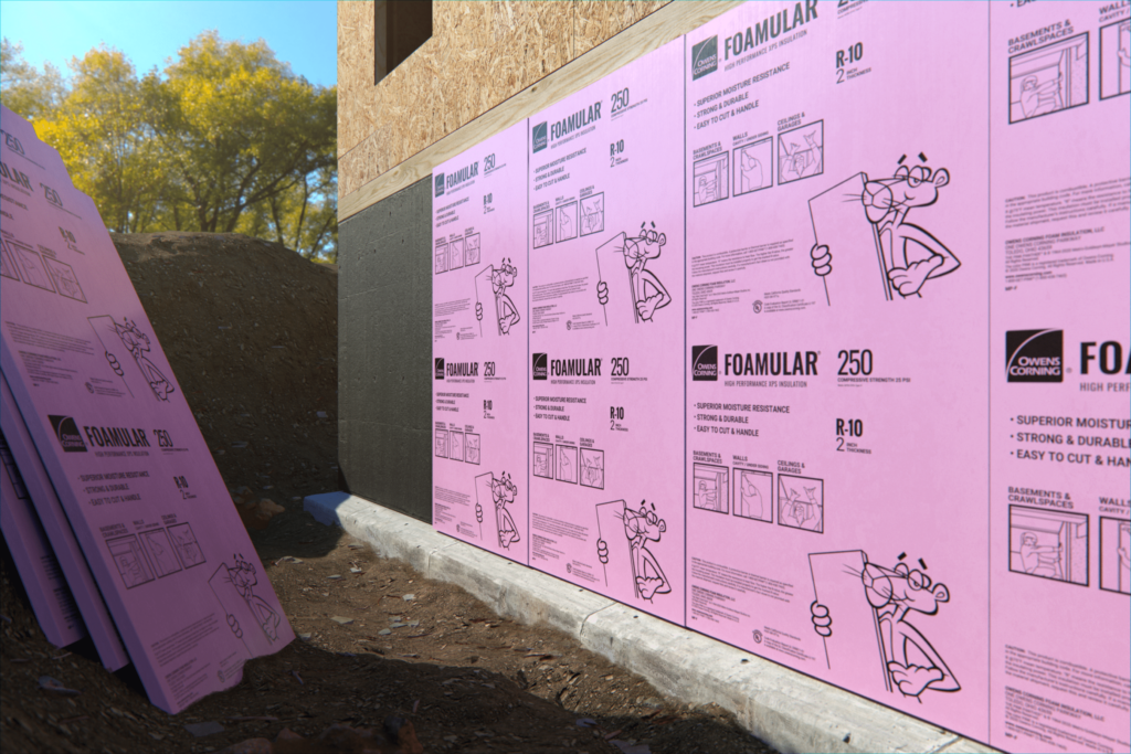 Pink rigid foam insulation boards from Owens Corning installed into the sides of a new construction project.
