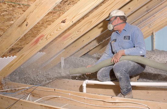 fiberglass blown-in insulation being installed in an attic