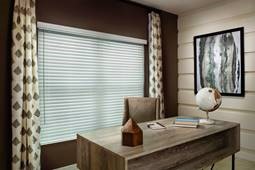 2” faux wood cordless window blinds over a large window in an office.
