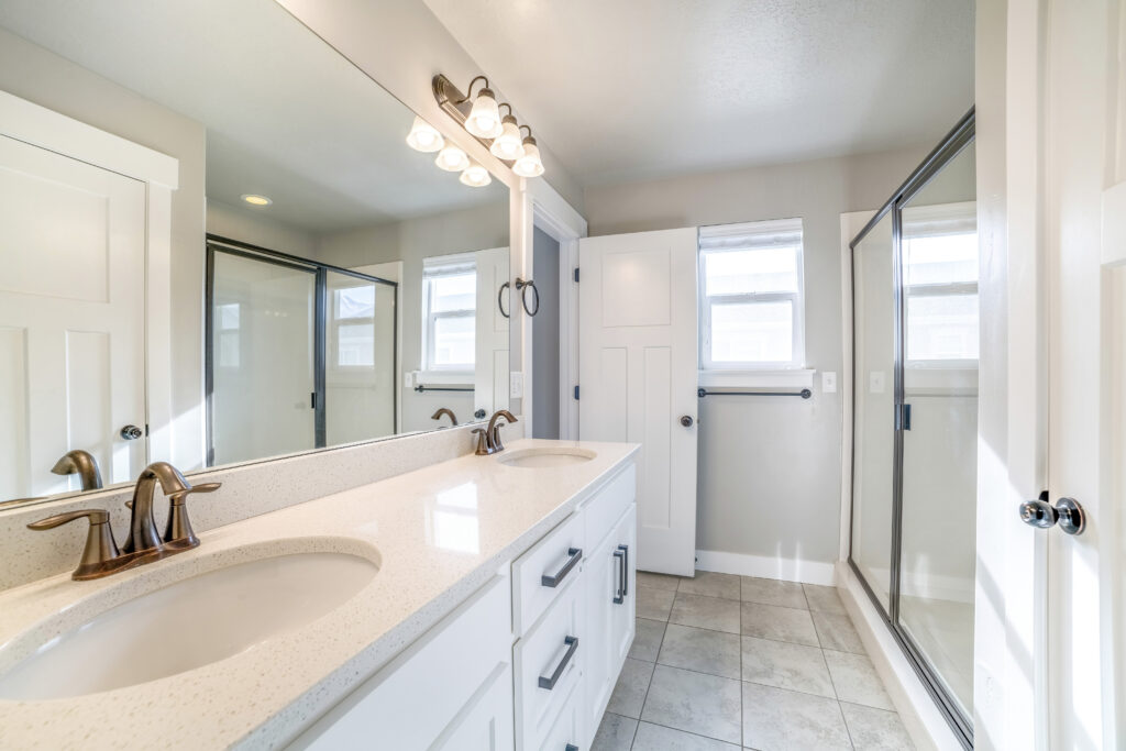 A modern interior of a bathroom with a big mirror