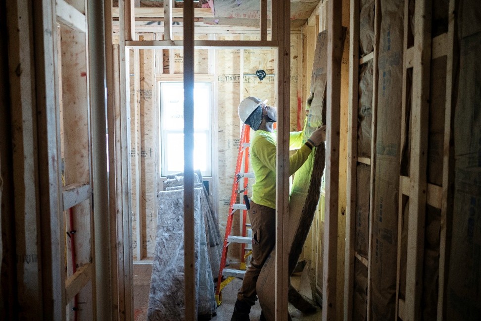 Technician installing insulation